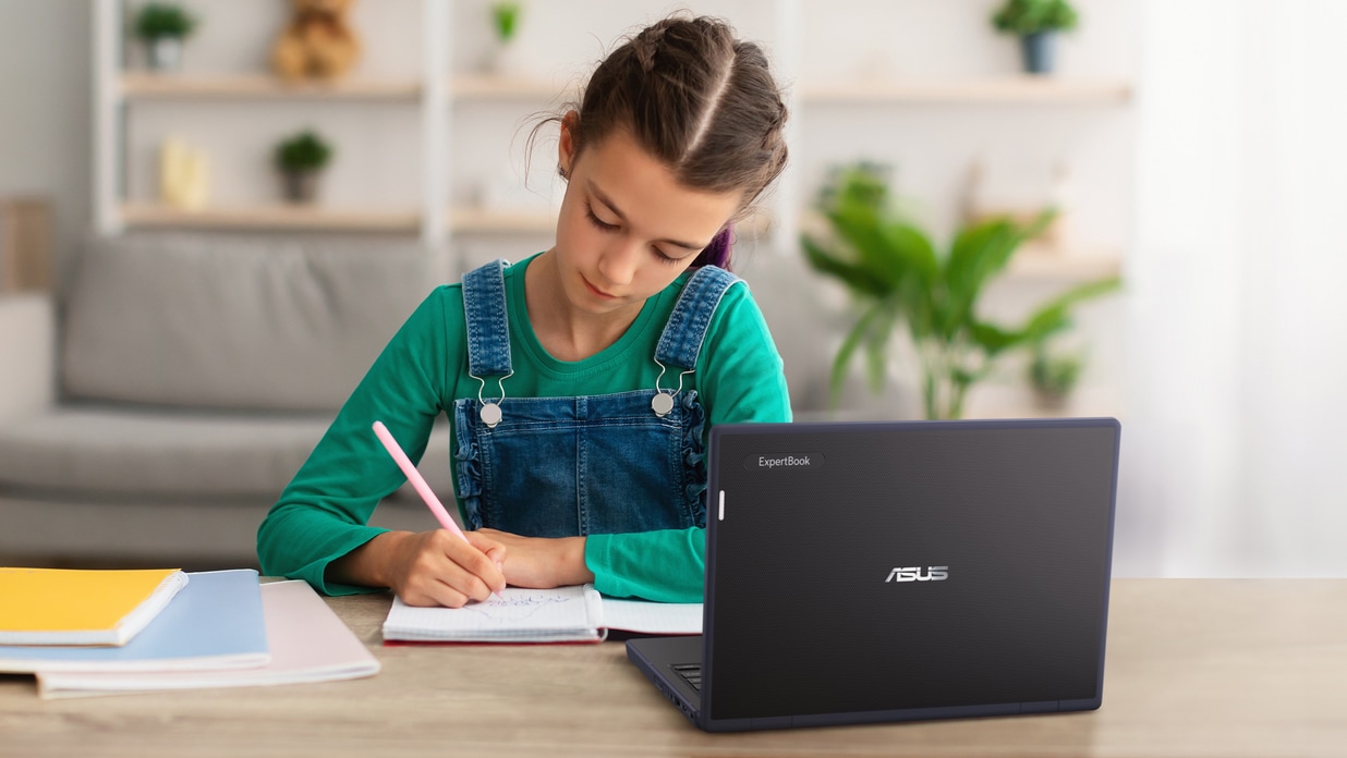 A girl doing homework at home with her laptop