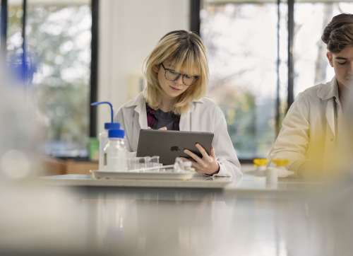 2 Students In A Science Lab In School Using Ipads