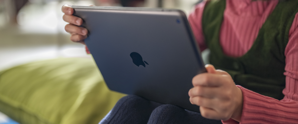 a female student sitting down with their ipad