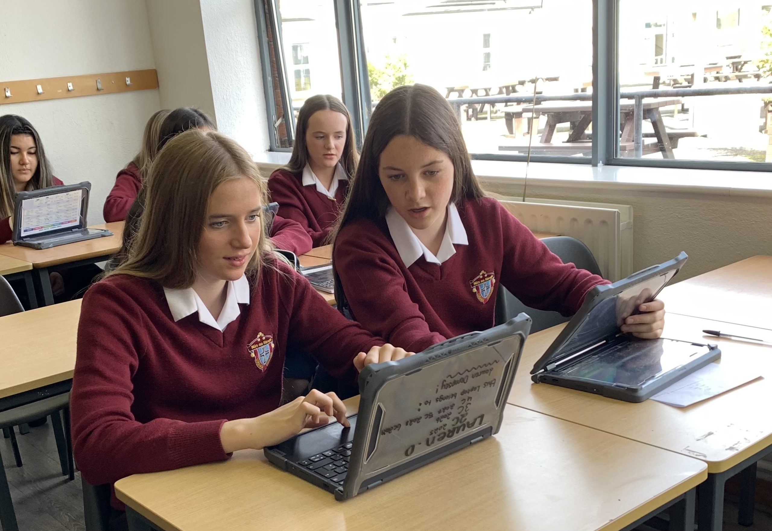 students using a laptop in school